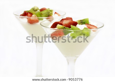 Two glasses of plain yogurt with fresh strawberries and kiwi