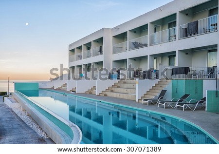 CRETE, GREECE - MAY 2015: Sunrise view on luxurious swimming pool in Greek spa hotel at Makrigialos on Crete island.