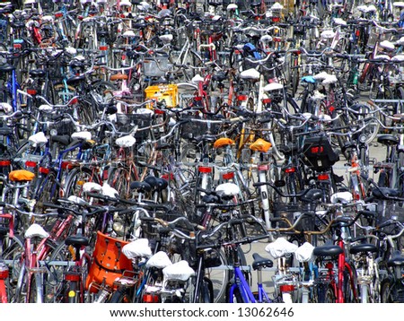 hundreds of bicycles parked together in a parking lot