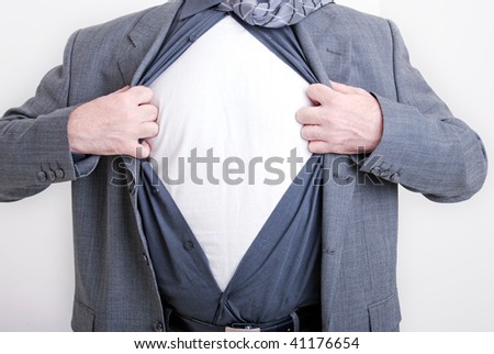 A business man tears open his shirt in a super hero fashion getting ready to save the day.