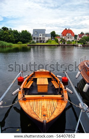 An image depicting the peacefulness of life by the riverside in the quiet swedish town of Ahus.