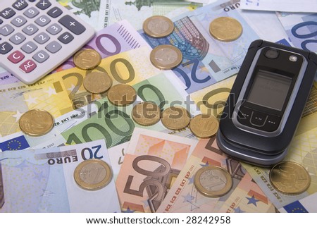 Money, calculator and mobile telephone