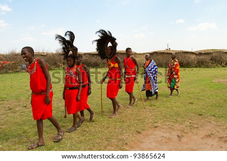 MASAI MARA, KENYA - AUGUST 24: A group of kenyan of Masai tribe performs a traditional dance to welcome their visitors on August 24, 2011 in a local village near Masai Mara National Park, Kenya.