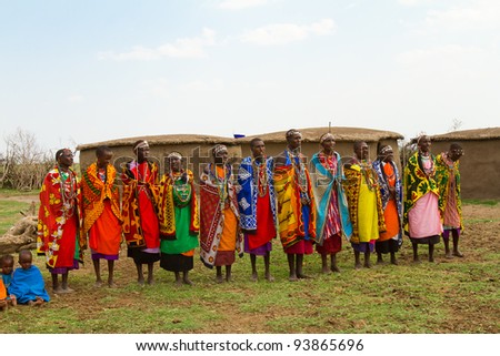 MASAI MARA, KENYA - AUGUST 24: A group of kenyan women of Masai tribe sings a traditional song to welcome their visitors on August 24, 2011 in a local village near Masai Mara National Park, Kenya.