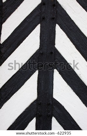 Panel details on the exterior of a Tudor / medieval half-timbered black and white building.