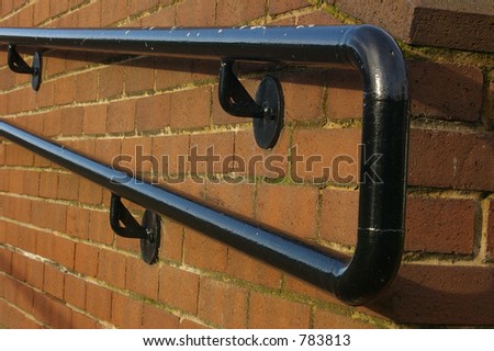 A hand-rail on a wall alongside a set of steps up to the magistrates courts in St. Helens, Merseyside.