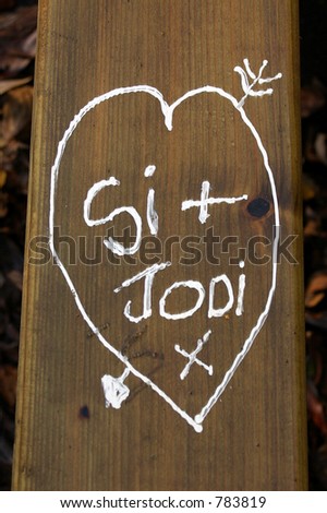 A graffiti message of love on a picnic bench seat at Pickerings Pasture Nature Reserve, Widnes, Cheshire, UK