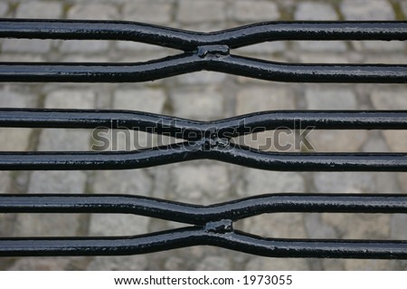 The black metal bars / slats comprising the seating area of a street furniture bench in Liverpool.
