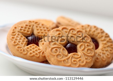 plate of patterned raspberry jam cookies