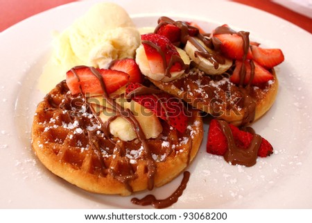 Belgian waffles with ice cream, chocolate and strawberries