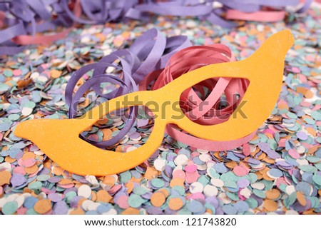 Carnival stuffs, mask, confetti and serpentine (roll).