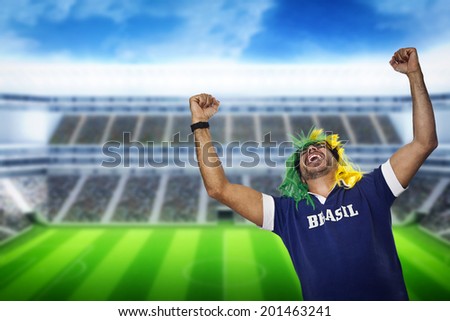 Brazilian fan with wig screaming at stadium