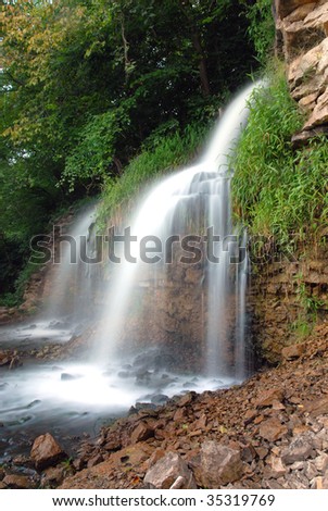 A side view of a fast moving waterfall shot using a slow shutter speed to give the water a silky smooth appearance.