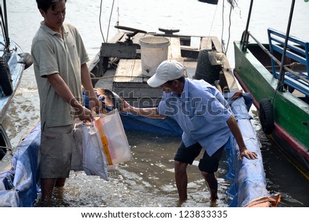 MY THO, VIETNAM - FEBRUARY 14: Fisherman on boat on February 14, 2012 in My Tho, Vietnam. Government will set up forces to protect vietnamese fisheries and sovereignty on sea for early next year.