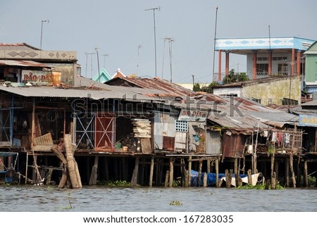 MY THO, VIETNAM - FEBRUARY 14: Houses on the bank of Mekong river on February 14, 2012 in My Tho, Vietnam.