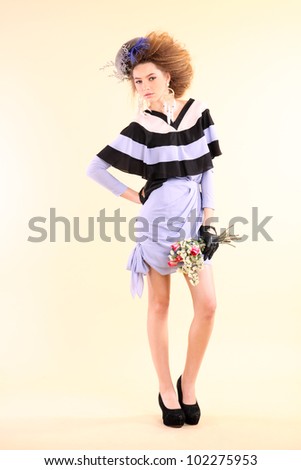 Fashion model in spring light purple clothes on beige background.