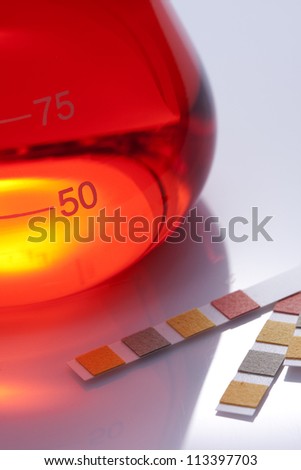 Red chemical liquid and ph Indicator paper