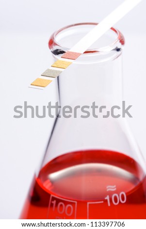 Red chemical liquid and ph Indicator paper