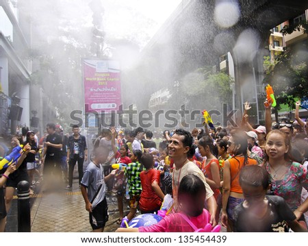BANGKOK - APRIL 13: Crowd of people celebrating the traditional Songkran New Year Festival, April 13, 2013, Silom road, Bangkok, Thailand.