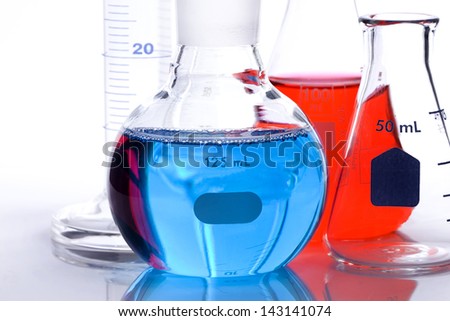 Scientific laboratory glass conical Erlenmeyer flask with red chemical liquid element suspension for a chemistry experiment in a science research lab