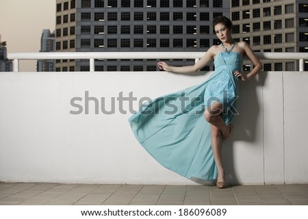 Young beauty famous woman in blue dress outdoor fasion in glamour style.