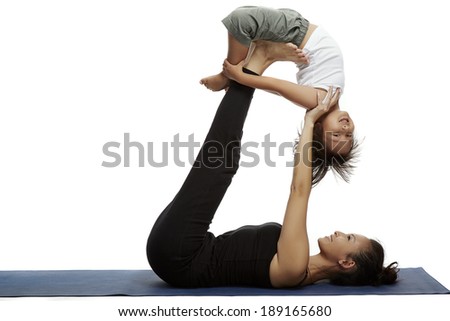 Mother and child doing yoga together in a fitness studio Mother and child doing yoga together in a fitness studio