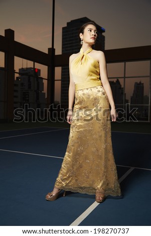 Young beauty famous woman in gold dress outdoor fasion in glamour style.