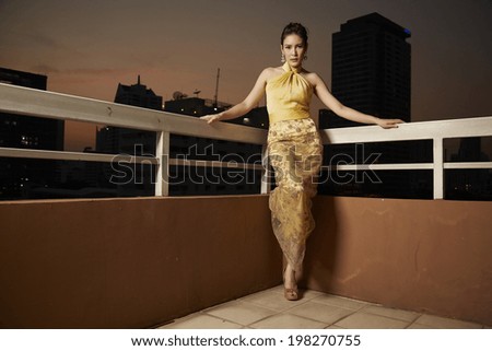 Young beauty famous woman in gold dress outdoor fasion in glamour style.