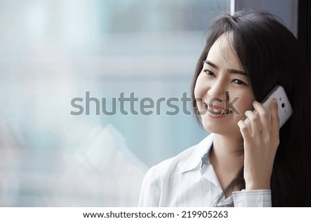 Close up young business woman speaking mobile phone.
