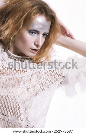 Fashion model in creative silver artistic make-up stylish on the white background.