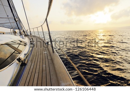 Yacht sailing towards the sunset
