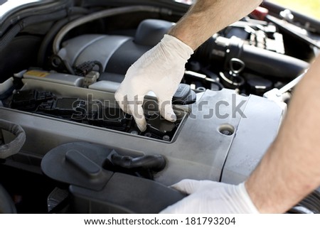 New spark plugs of a car being installed during a service