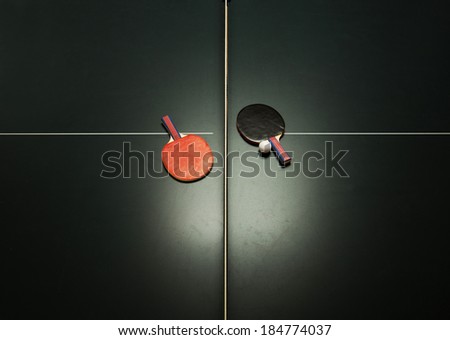 Birds eye view of table tennis table and ping pong paddles. Concept of sports competition
