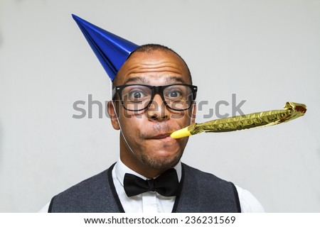 Party celebration with this young geek with a hat and party blower. Christmas, office or birthday concept