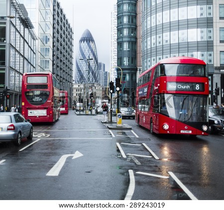 London, UK - June 20, 2015 - London city street with public transport and the Gherkin building in the distance