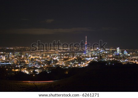 Auckland City New Zealand, showing the harbour bridge and Sky Tower at night