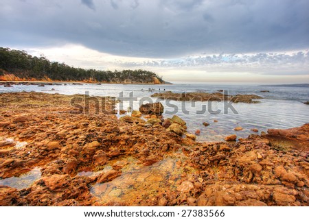 Rock pools against a cloudy sky in Eden, NSW