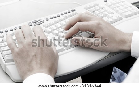 Man typing on a computer keyboard