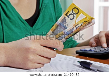 Girl counting money against white background