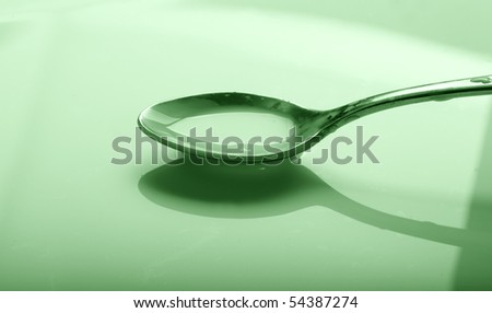 a spoon full of syrup over a bowl
