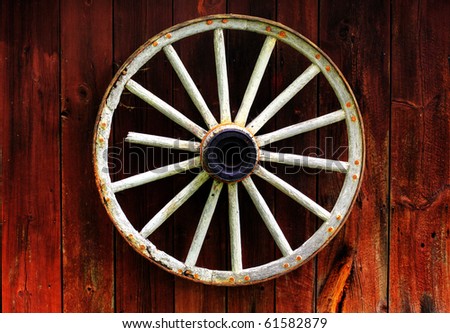 rustic wagon wheel hanging on a wall