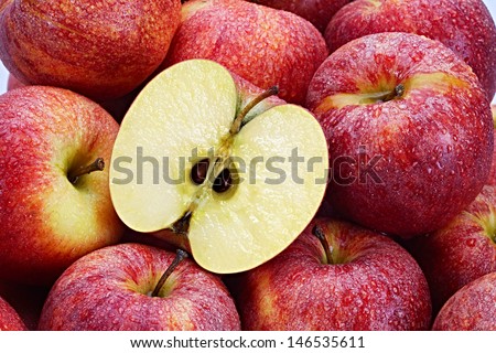 Several Red Apples with cut apple in the foreground