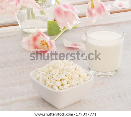 Cottage cheese with milk and pink  and white terry tulips