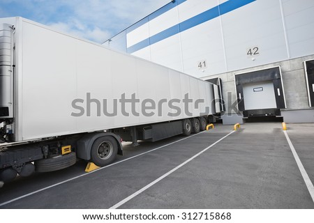 Big distribution warehouse with gates for loads and truck