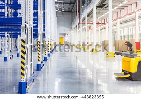 Big distribution warehouse with forklift for loading goods