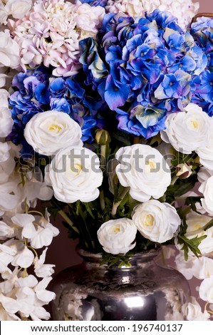 close-up of a bouquet of roses and hydrangea in a vase