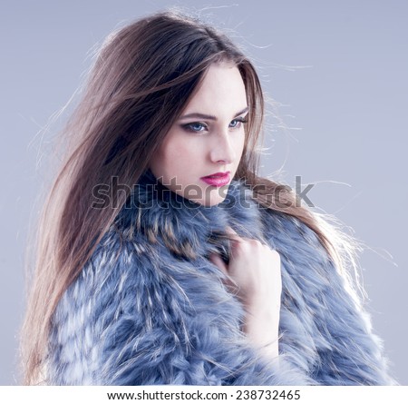 Winter fashion woman in a fur coat.
