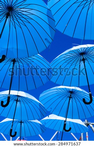 Blue umbrellas  on a background of clear sky.