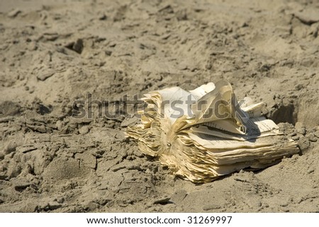 Old Book in the dutch language on shore of beach