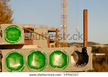 Concreted block at a construction site, plugged with green
